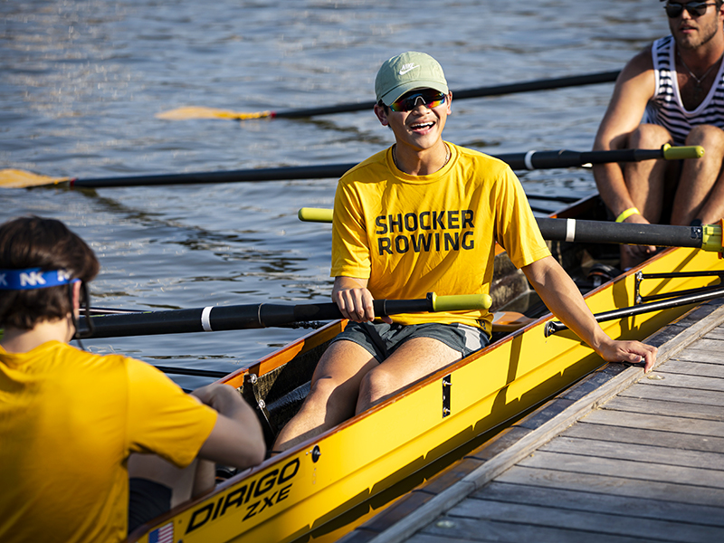 A Shocker Rowing student prepares to exit from the dock on the Arkansas River.