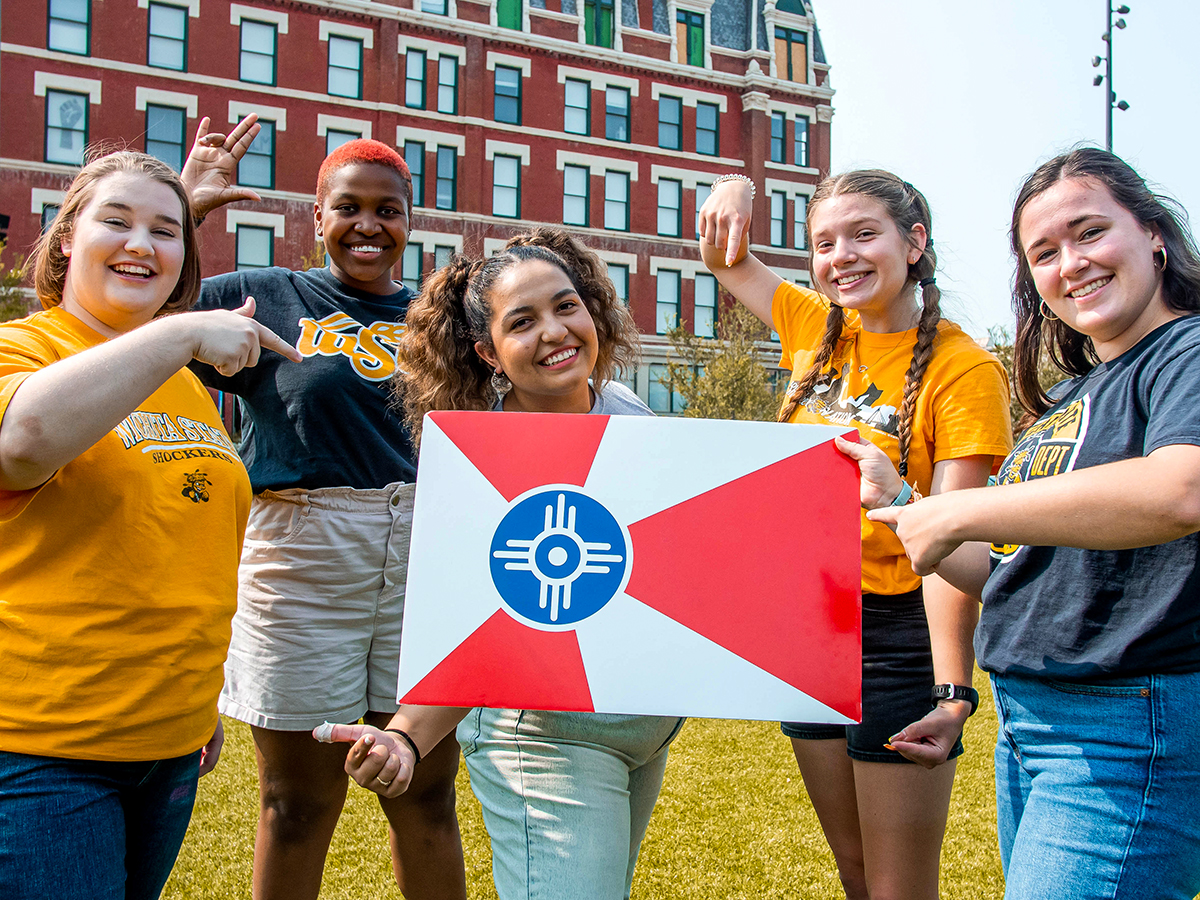 Wichita State students with the Wichita flag.