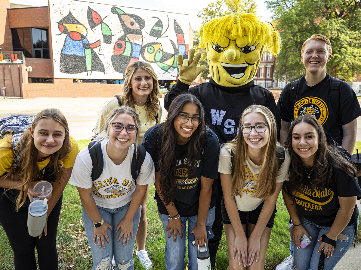 Shocker students posing for a photo with Wu outside of the Ulrich Museum of Art.