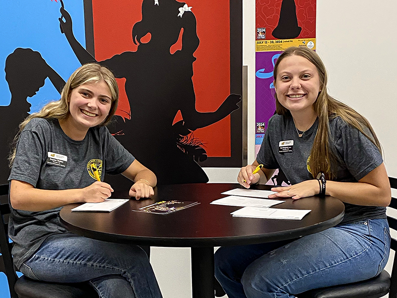Sophie and Kyra Bergman writing postcards for SAS.