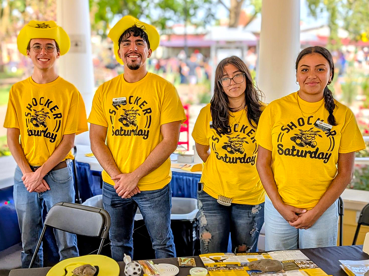 Samir Barraza, second from left, volunteering during Shocker Saturday at the Kansas State Fair.