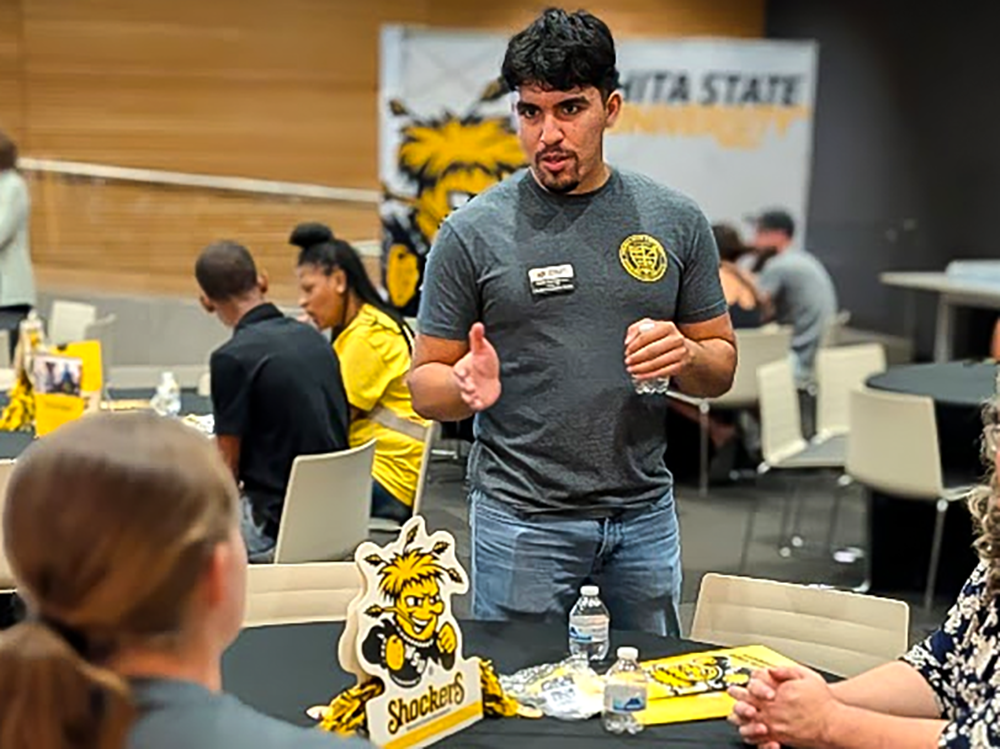 Samir Barraza talking with a prospective student during Discover Wichita State in Tulsa, Oklahoma.
