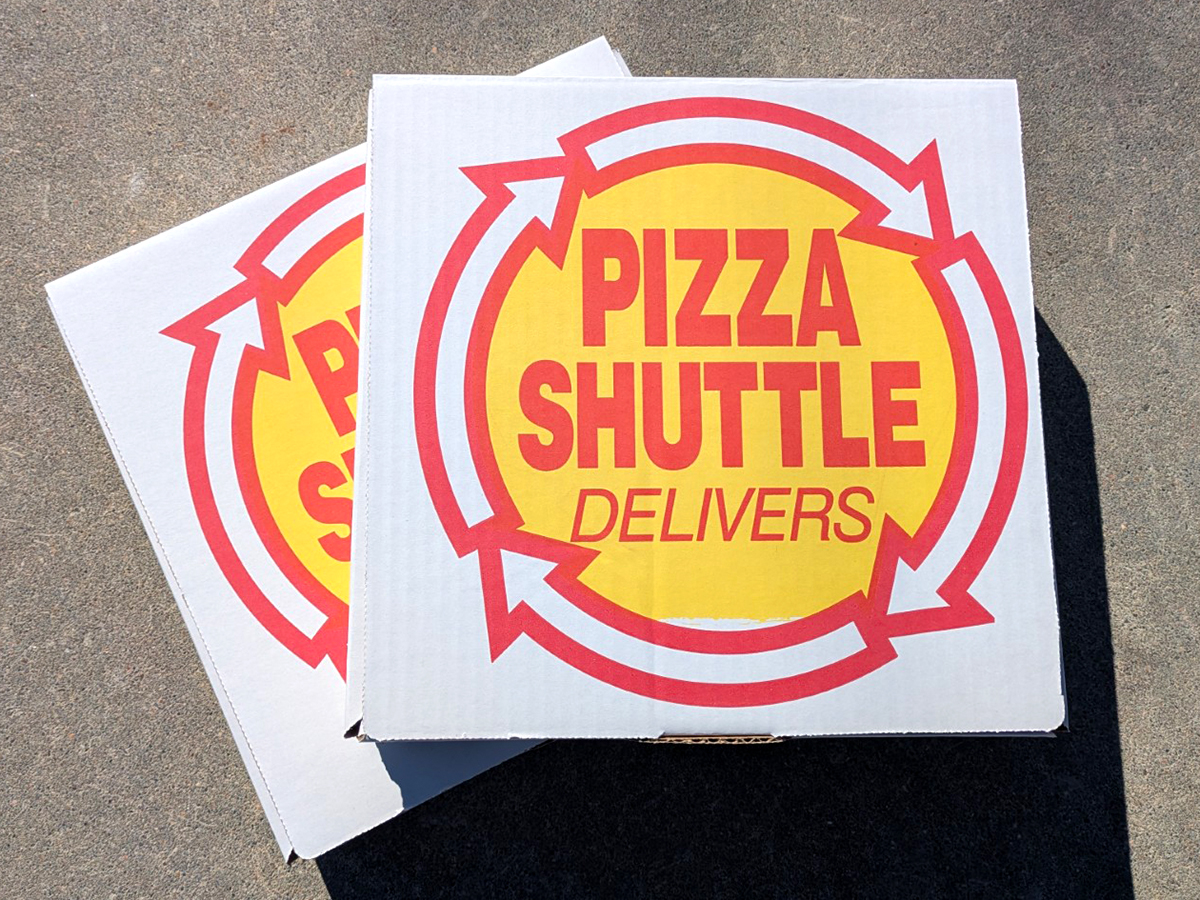 Pizza Shuttle logo and delivery box.