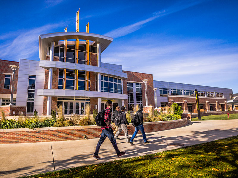 Students walk in front of the Rhatigan Student Center's east entrance