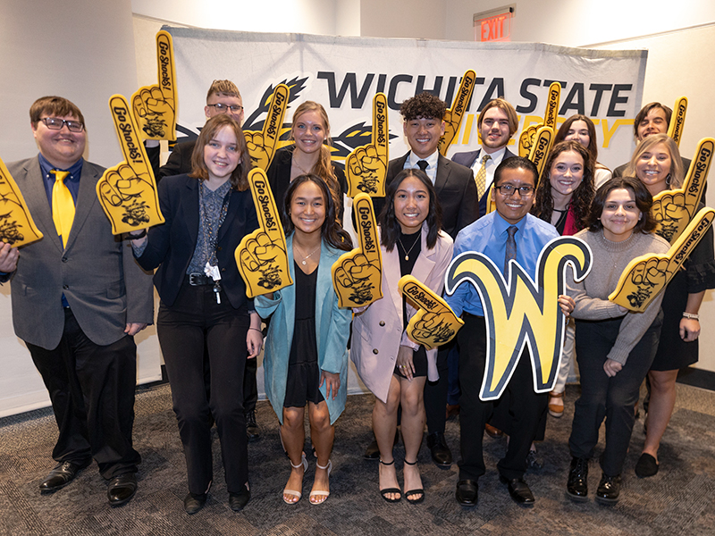 A group of current Shocker Rudd scholars poses with yellow foam fingers