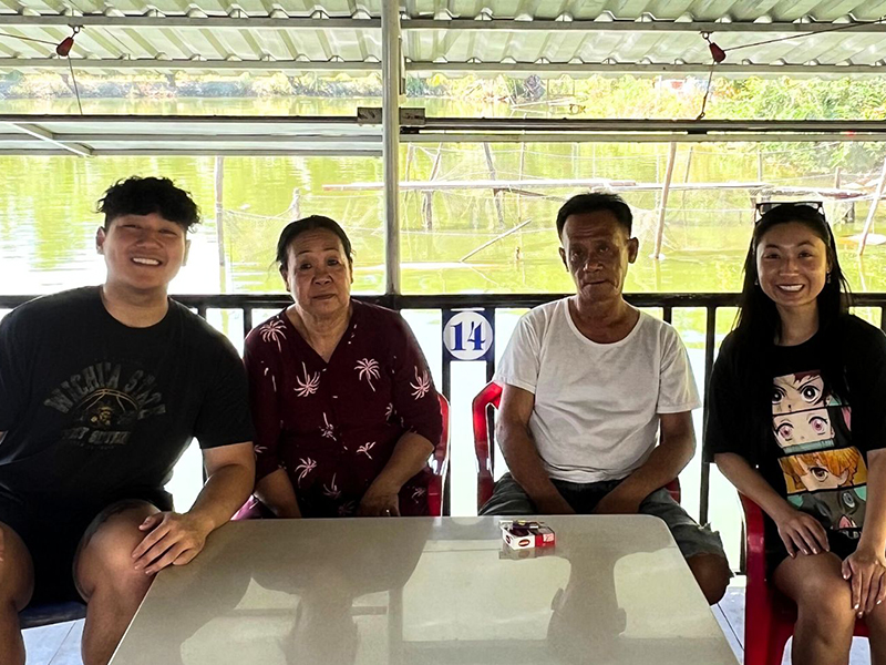 Gary poses with family during his travels in Vietnam