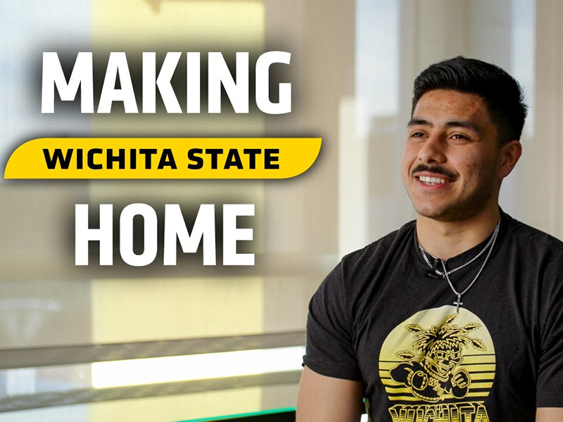 Rafael Guereque sits for a photo. The text, "Making Wichita State Home" is visble to the left.