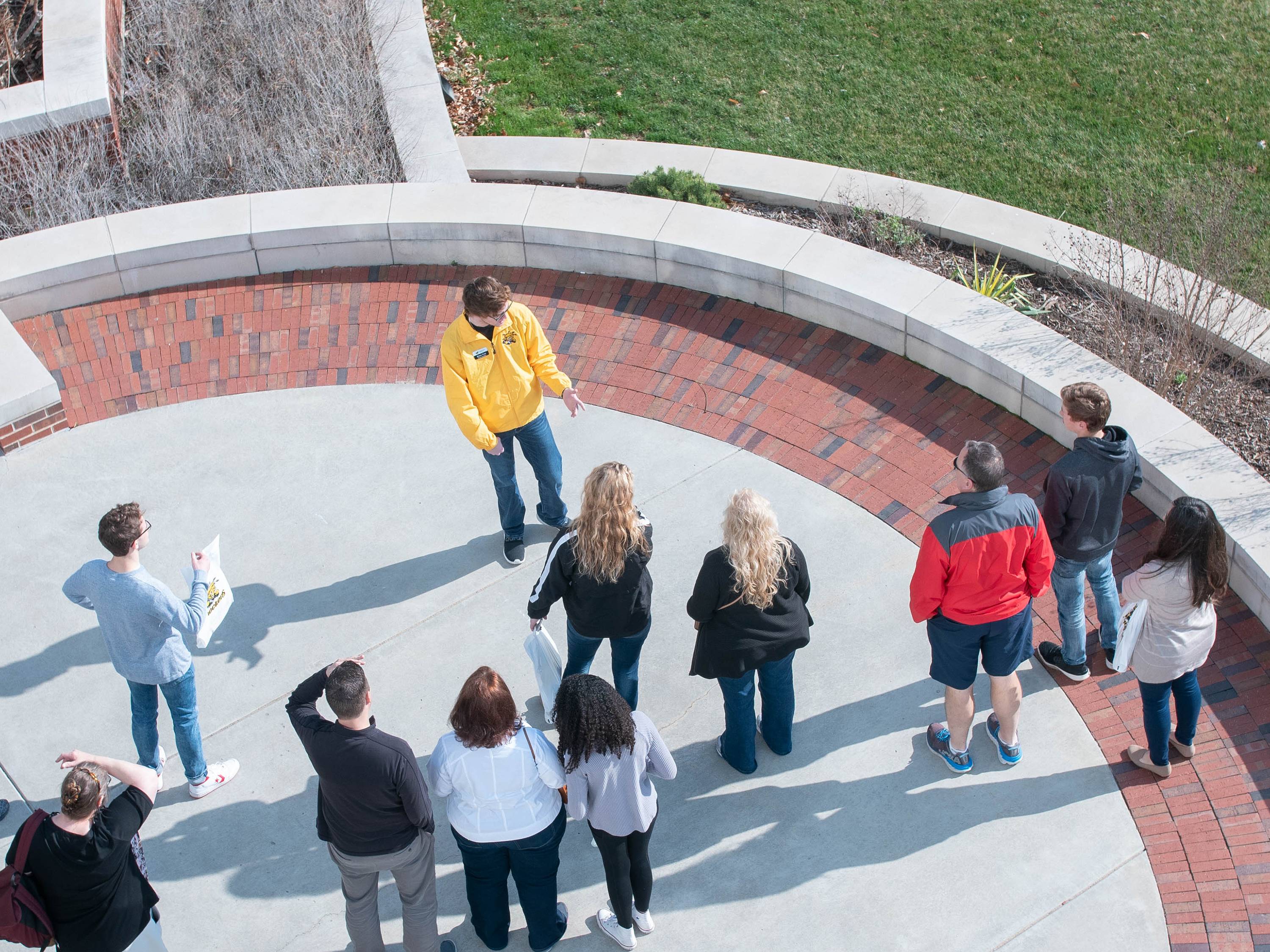 A group of students on a campus tour with a Shocker Navigator 