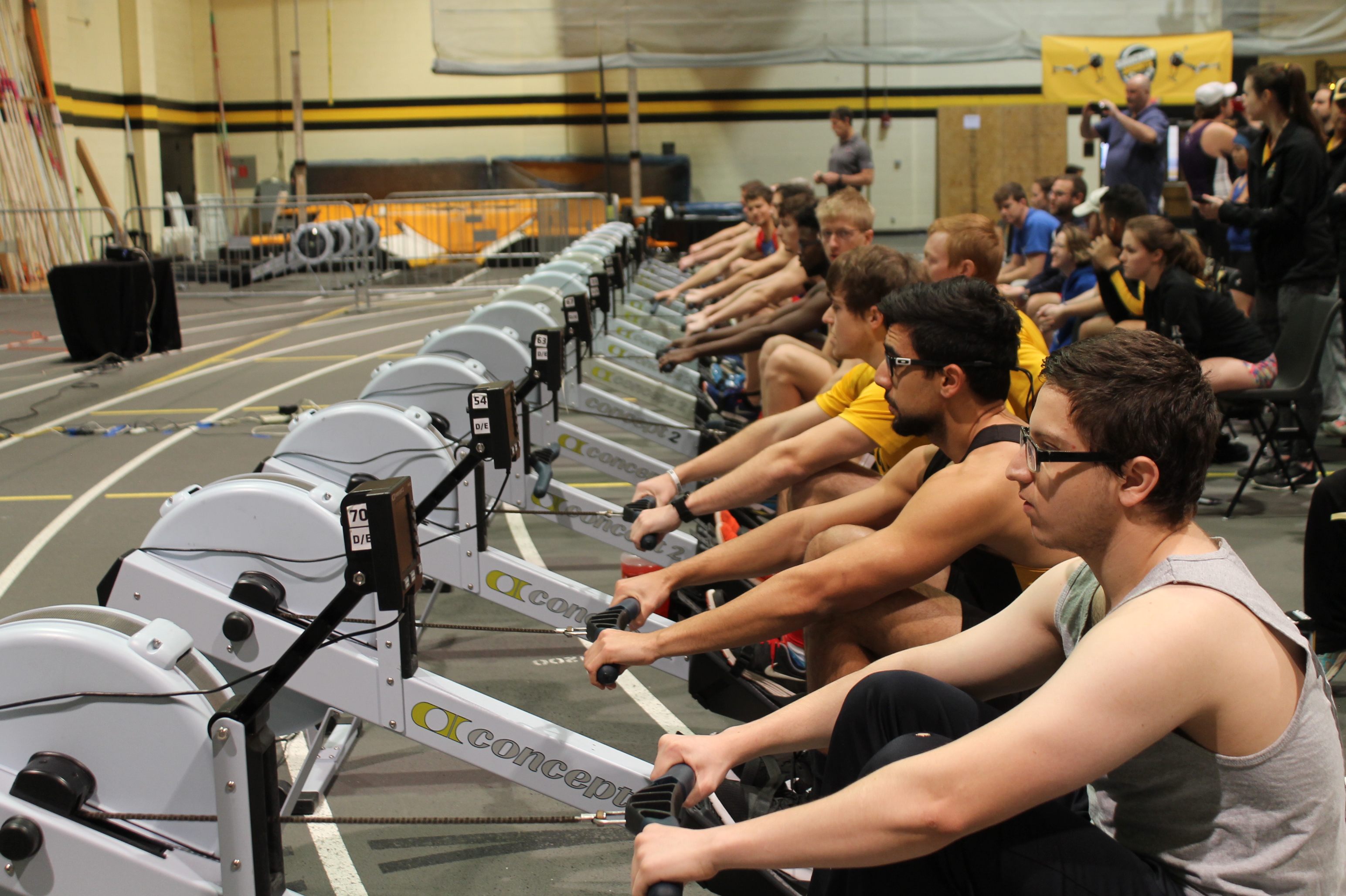 Looking down the row of ergometers at shocker sprints. its a men's event, and everyone is holding, waiting for the race to begin
