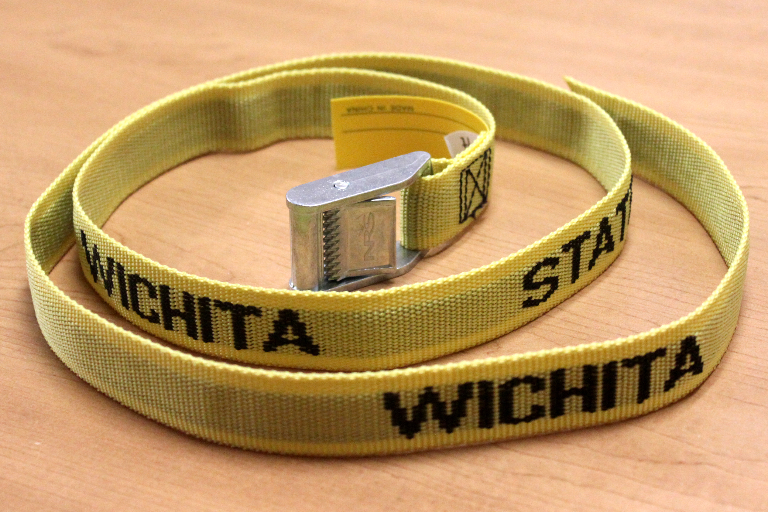 Photo of one of the belts. Belts are yellow with lettering reading, "Wichita State University."