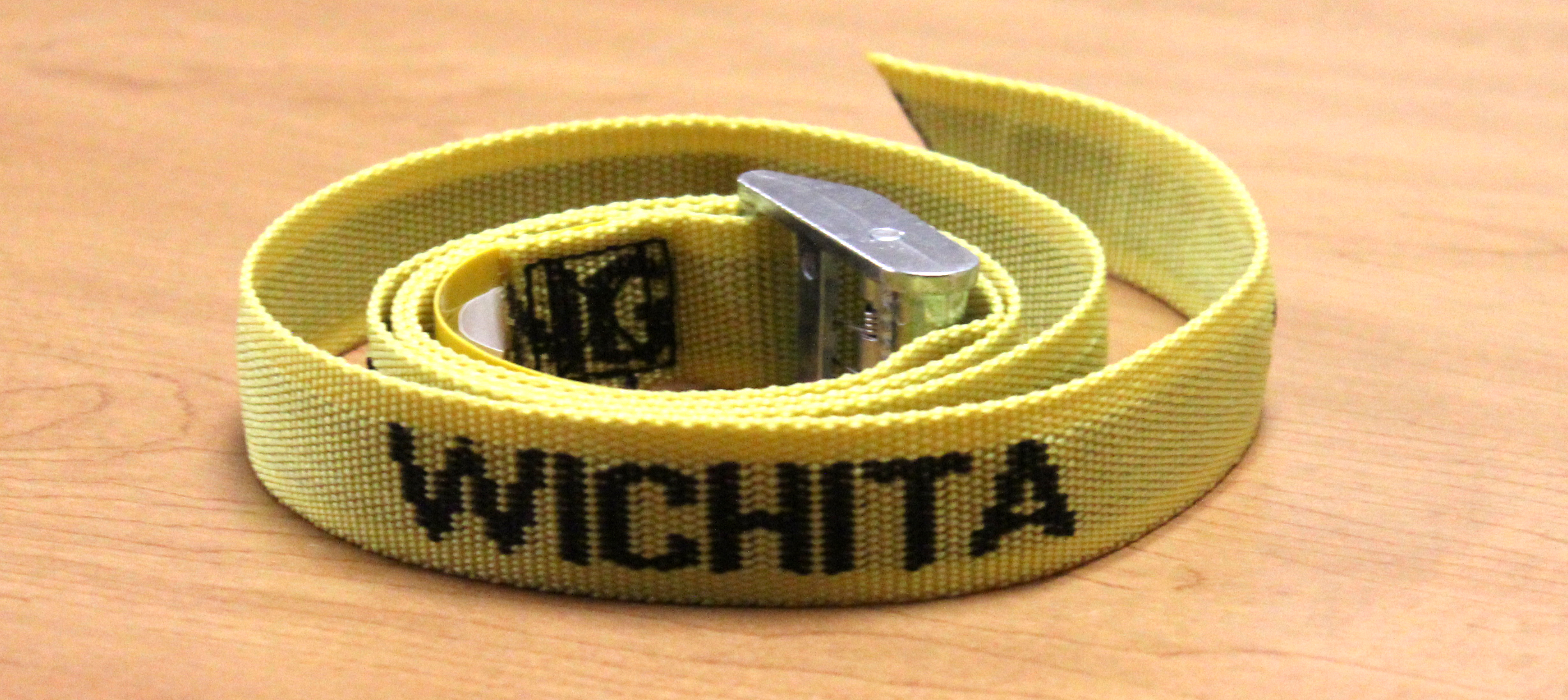 Photo of one of the belts. Belts are yellow with lettering reading, "Wichita State University."