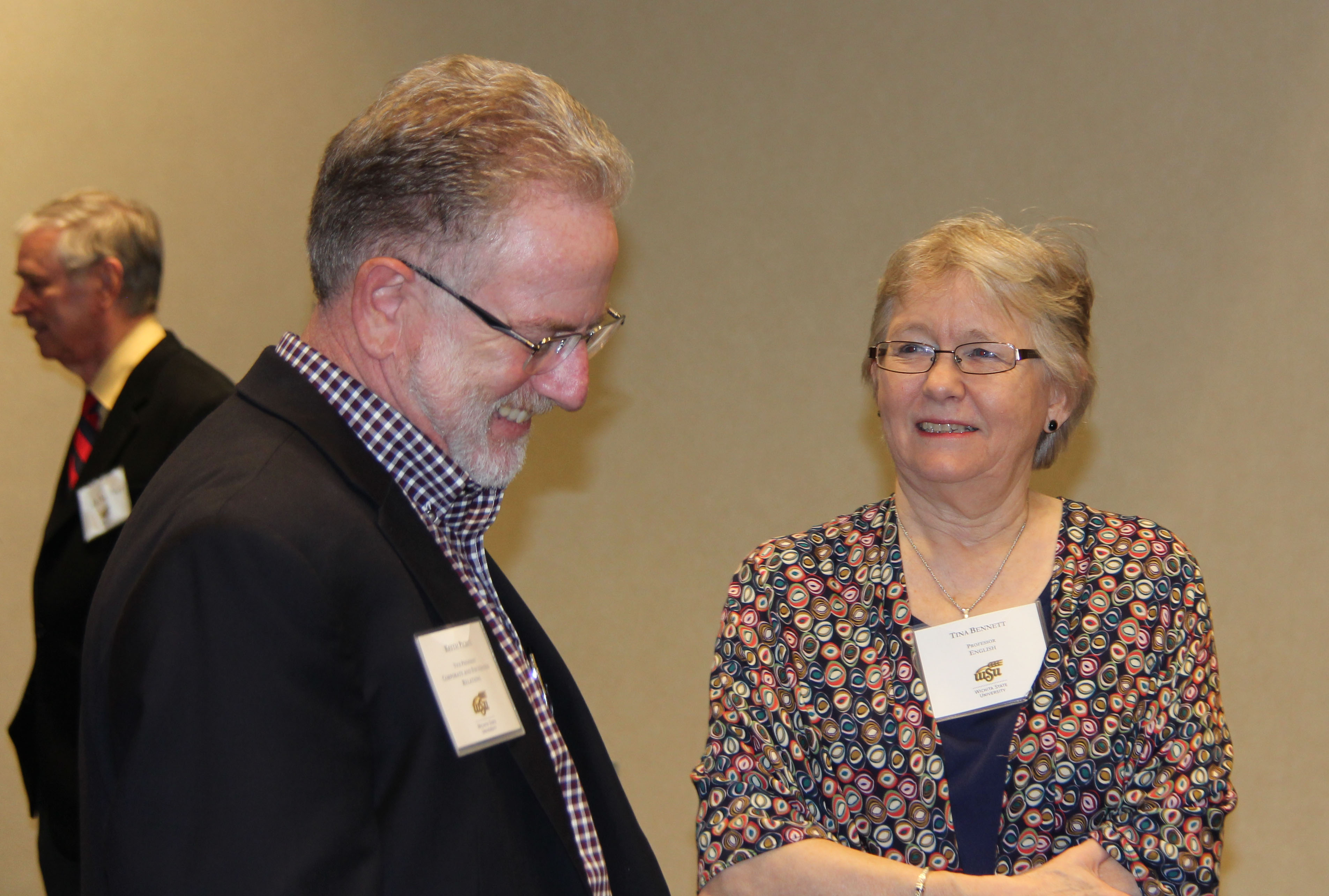 Photo of Keith Pickus visiting with AET New Inductee Tina Bennett.