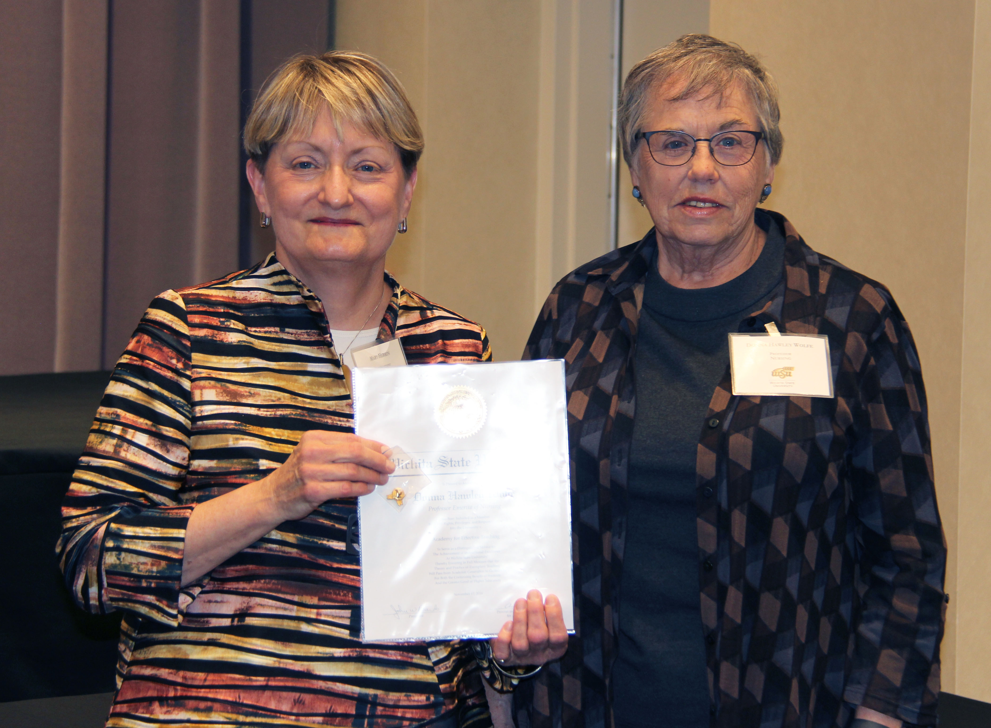 Photo of Mary Herrin presenting to Donna Wolfe.