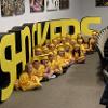 Child Development Center graduates pose for a photo in front of a Shockers backdrop