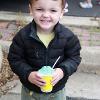 A child poses with their snow cone treat