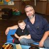 A father and son sit at a table in the Child Development Center.