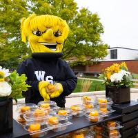 Wu holds up a cupcake and looks like he is trying to give it to you!