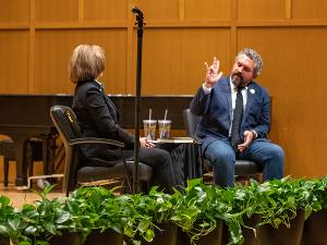 Cody Keenan shows the Shocker hand sign at the conclusion of the Barton Speakers Series event.