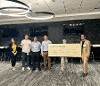 Nick Vasilescu, from Testkey, poses with the giant $25,000 check and the Finals judges.