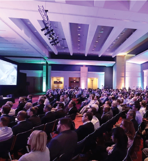 Photo of people at the SAMPE convention in a convention hall listening to a speaker.