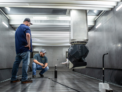 AMP employees working inside an automation machine