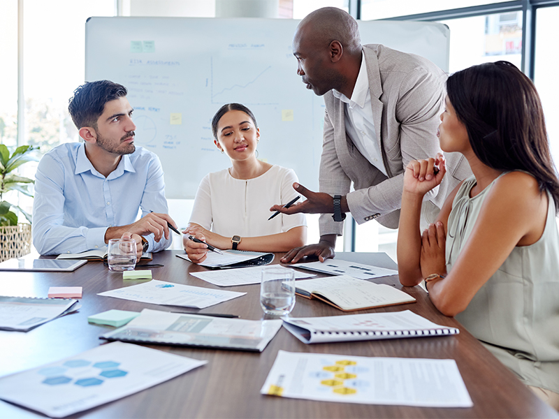 A photo of four people having a meeting
