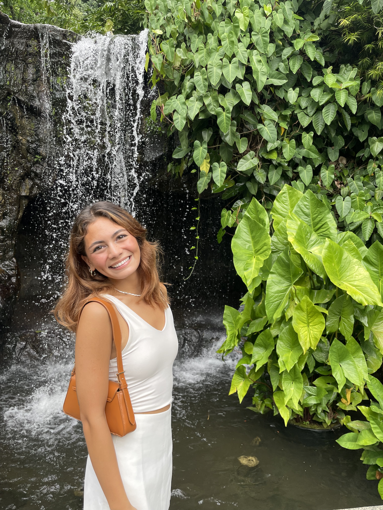 Photo of Hannah Harpel in front of a waterfall