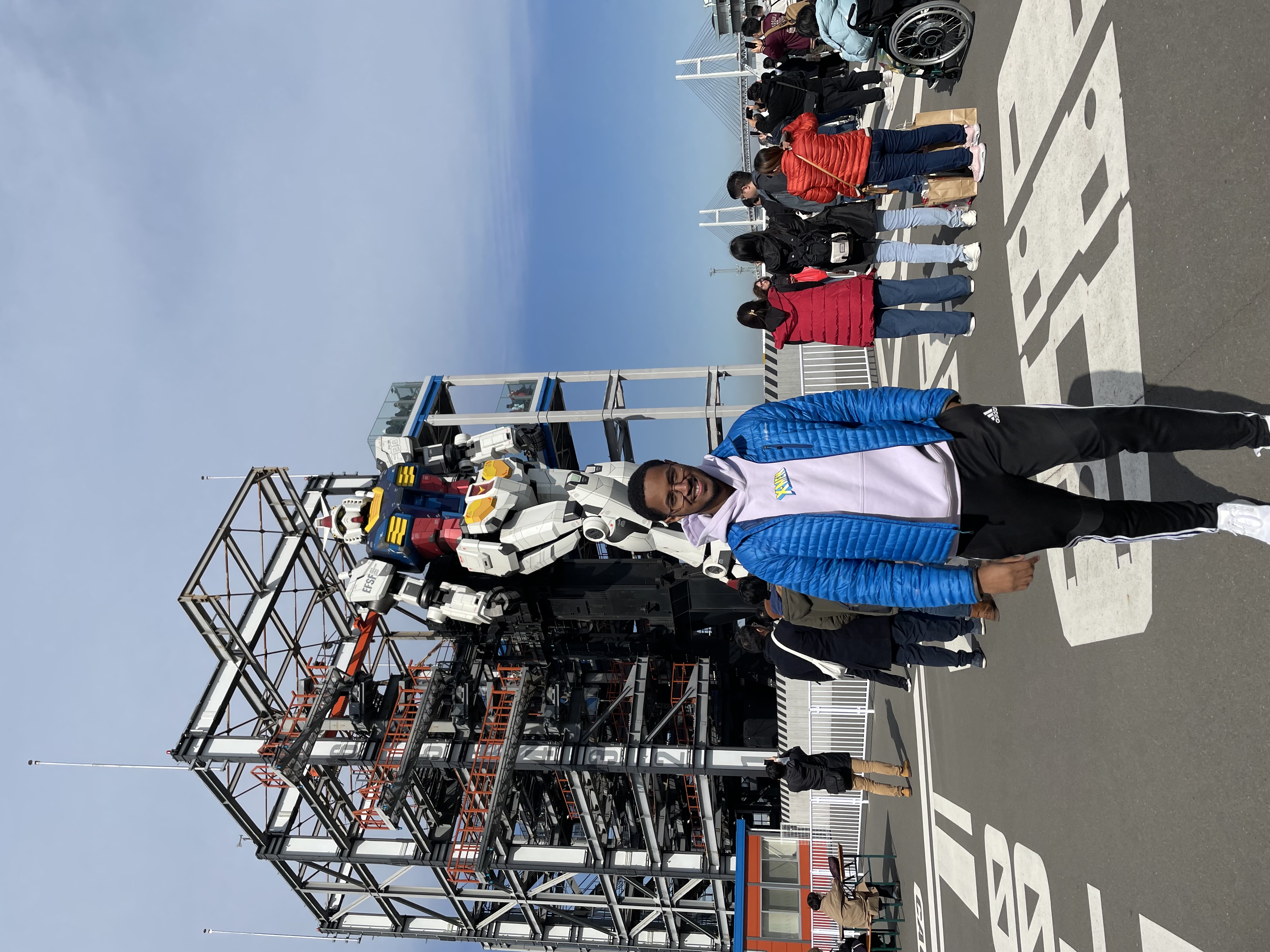 Photo of Payton in front of the Gundam Factory in Yokohama, Japan