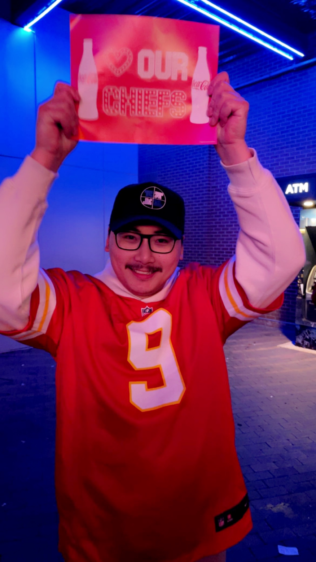 Photo of Peter Vu holding a Chiefs sign