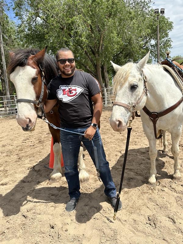 DaVontae Clemons leading 2 horses