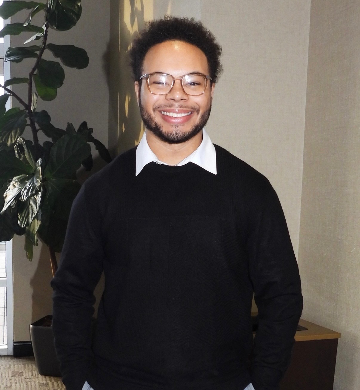 Photo of Cameron Davis in a sweater.