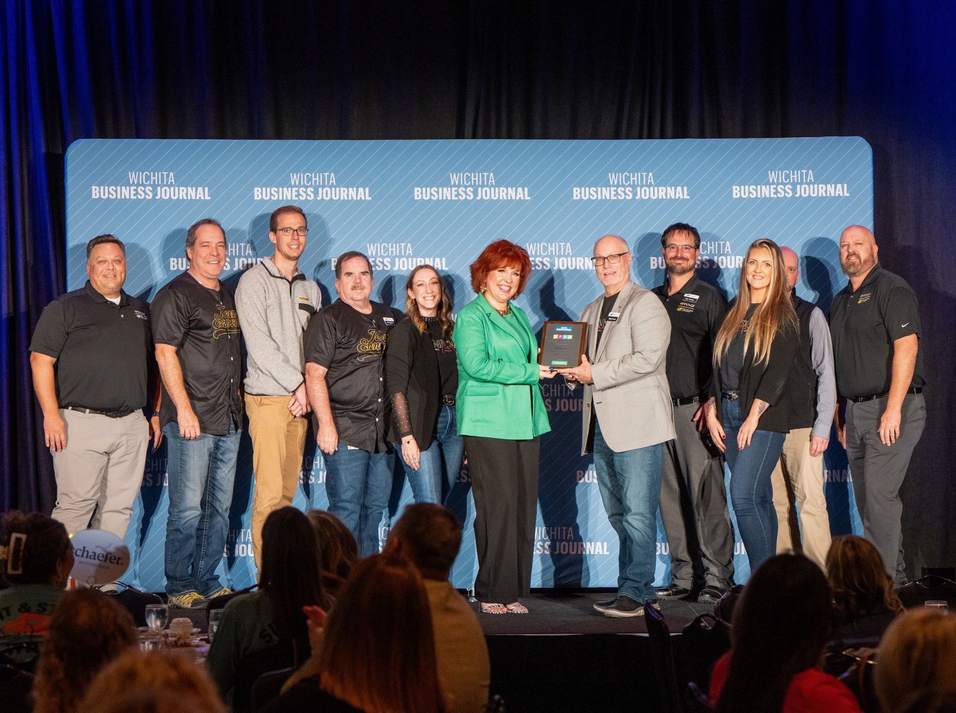 Photo of Ennovar staff recieving award plaque at Wichita Business Journal's Best Places to Work event