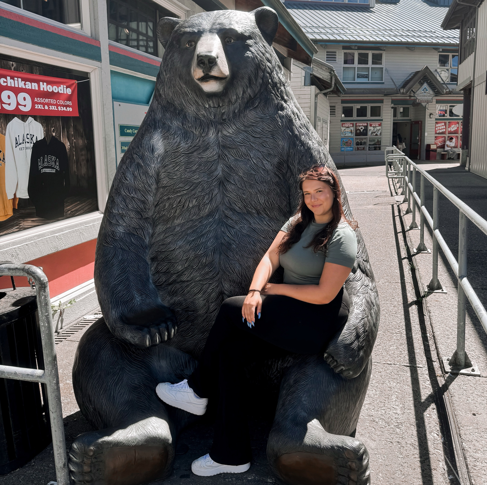 Photo of Amber DeSmit next to a bear statue