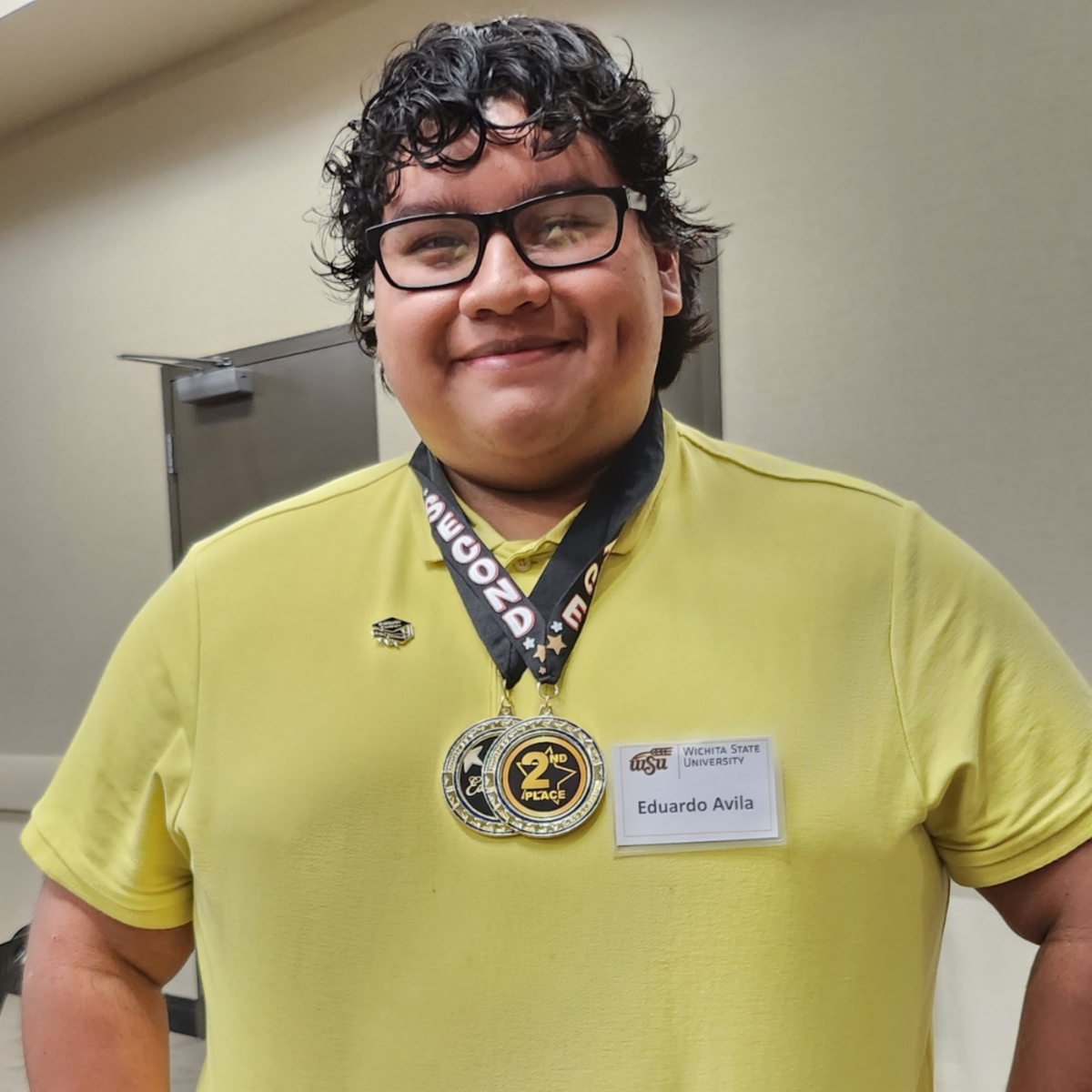 Photo of Eduardo Avila wearing two award medals