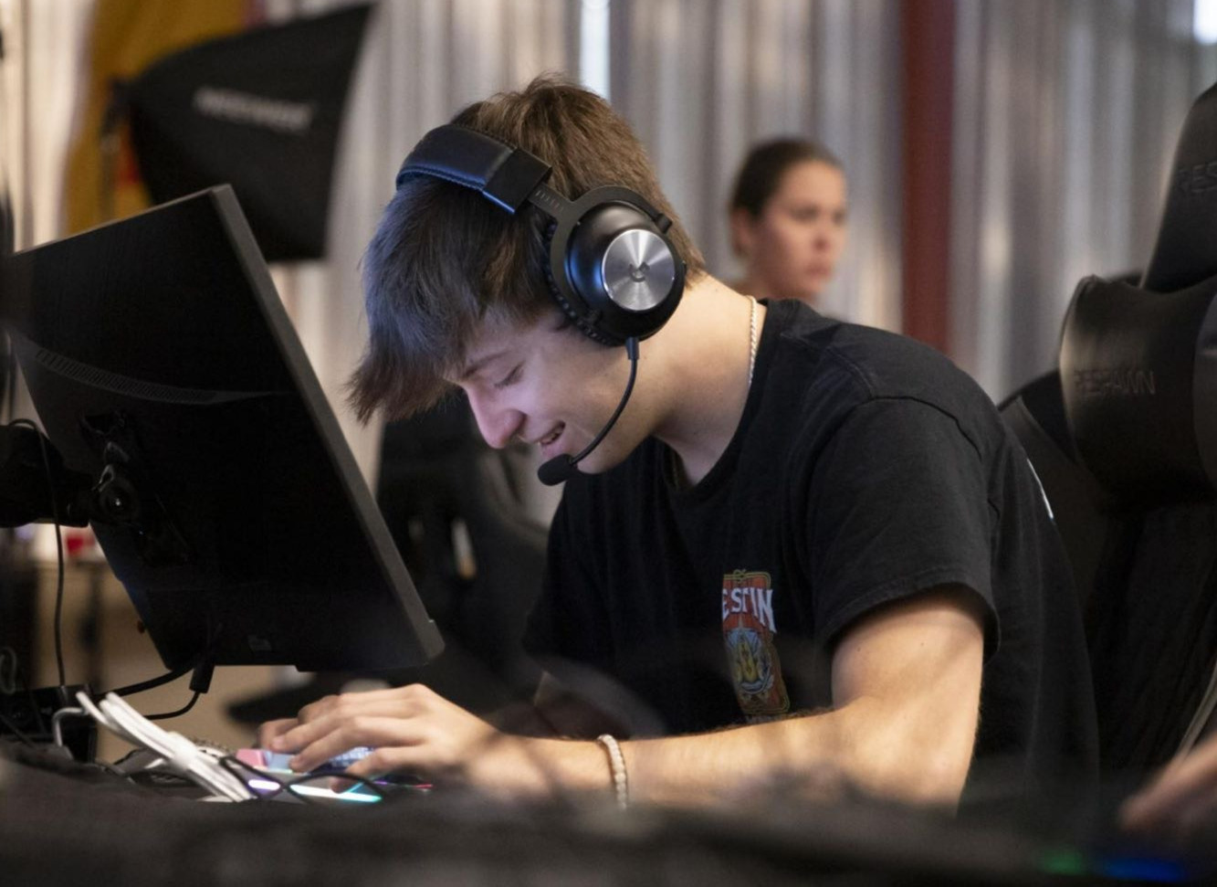 Photo of Caleb Allen in front of a computer