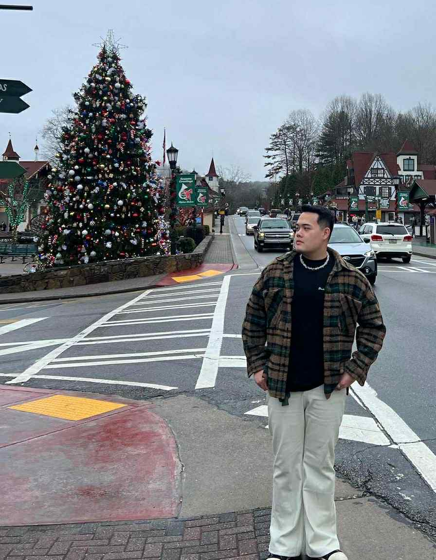 King Nguyen on a street corner decorated for Christmas