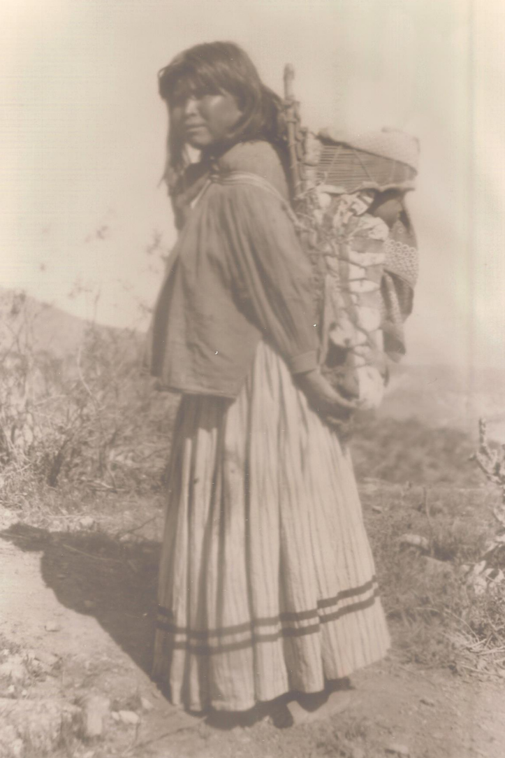 Woman carrying a baby in a cradleboard