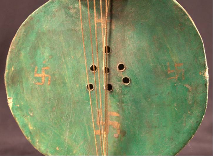 Close-Up of the Tungna's Base A close-up of the base of the instrument that better shows the four golden swastikas on the base.