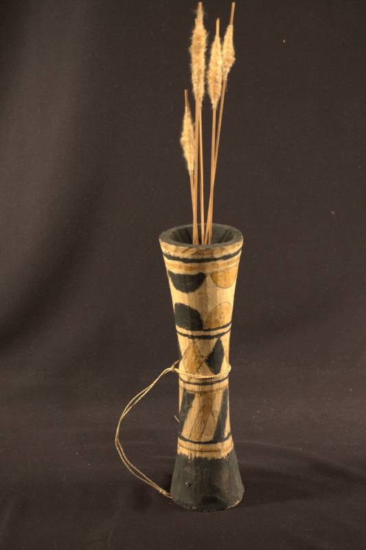 Quiver with Darts A wooden quiver decorated with stripes, diamonds, and half circle designs, holding four darts.