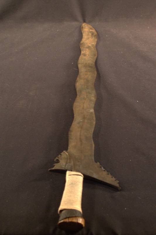 Kris Sword Steel blade with a wave shape and wooden handle.