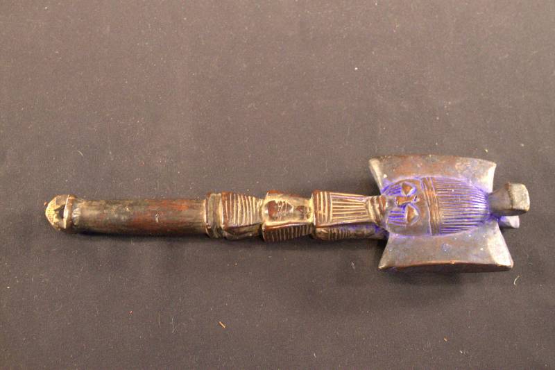 Dance Wand Dance wand with a face carved at the top and dyed blue.