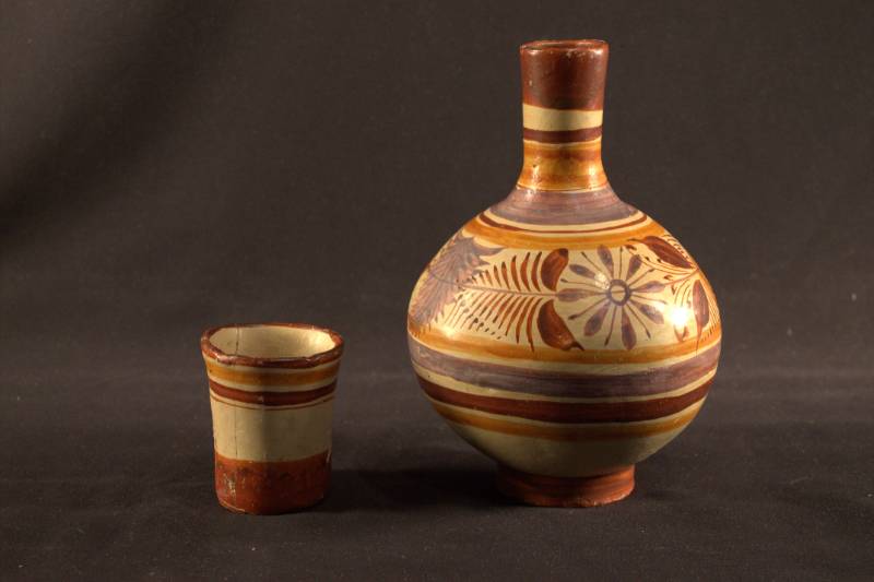 Jar and Cup Water jar and cup are sitting side by side