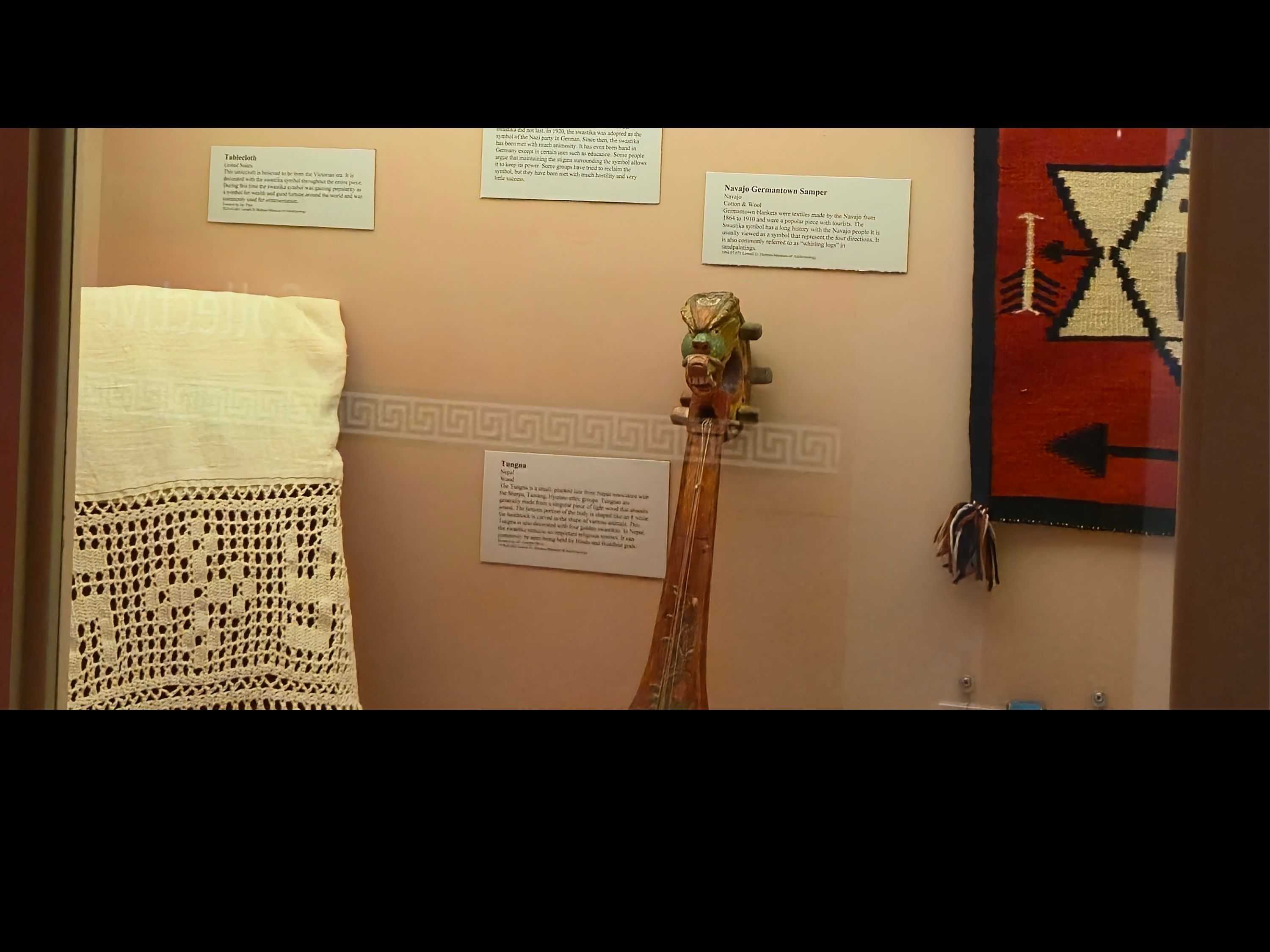 The case has a cream background with various objects on display.