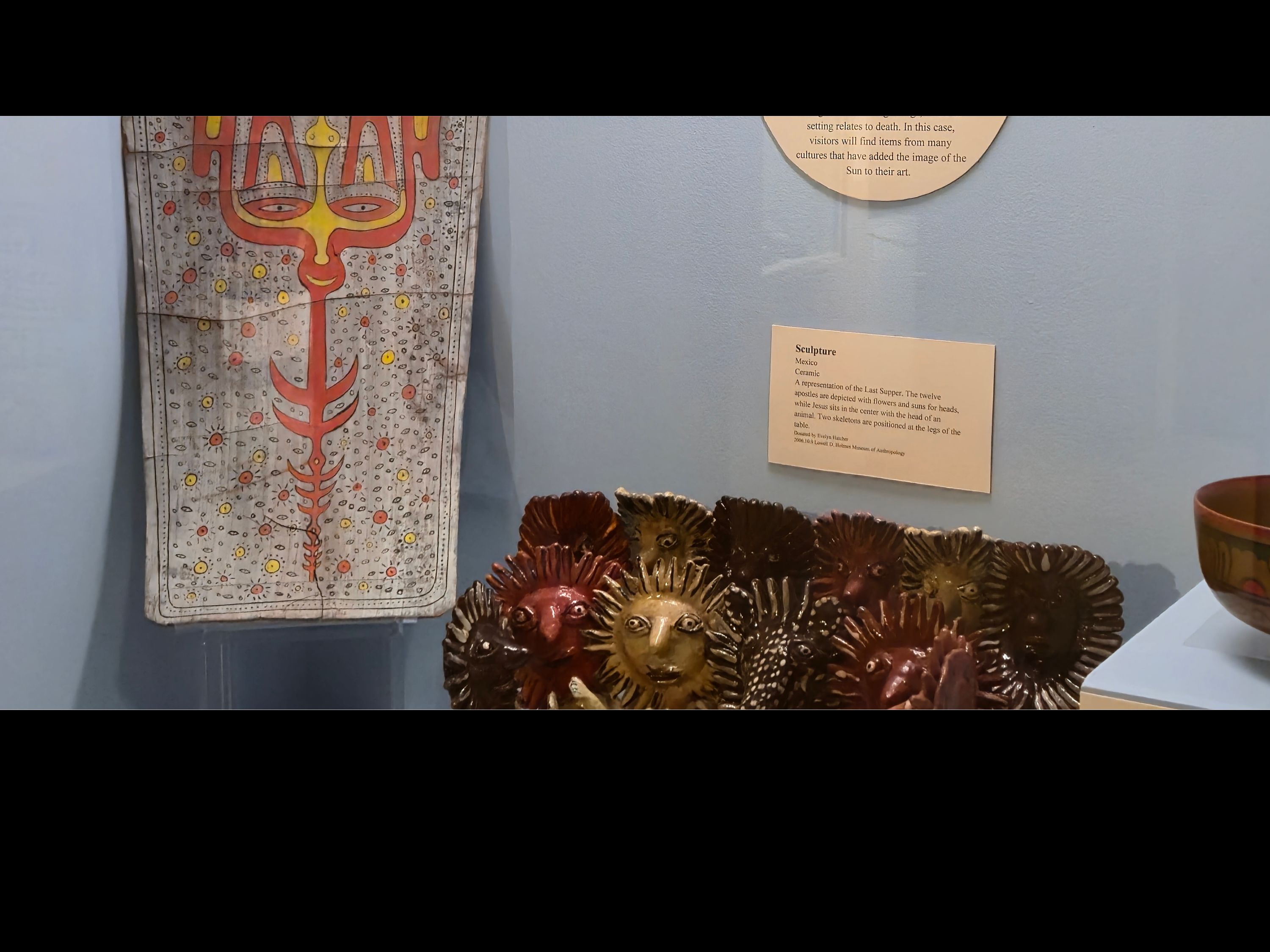 Case with a blue background and various objects on display.