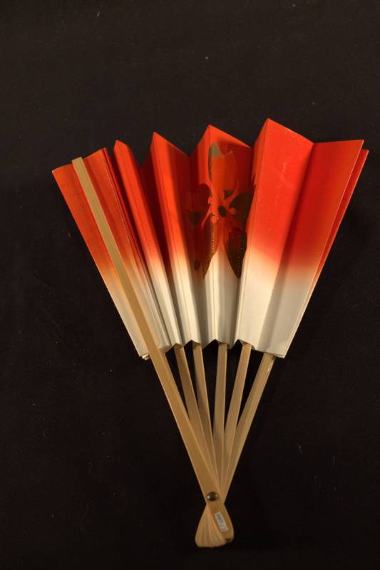 Plum Blossom Fan Fan frame is light colored bamboo, paper portion is a transition from white to bright red from the center outward with gold colored single flower design that is on both sides of the fan.