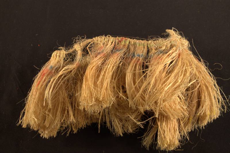 Arm Band Arm band made of plant fibers with faded colors along the top portion.