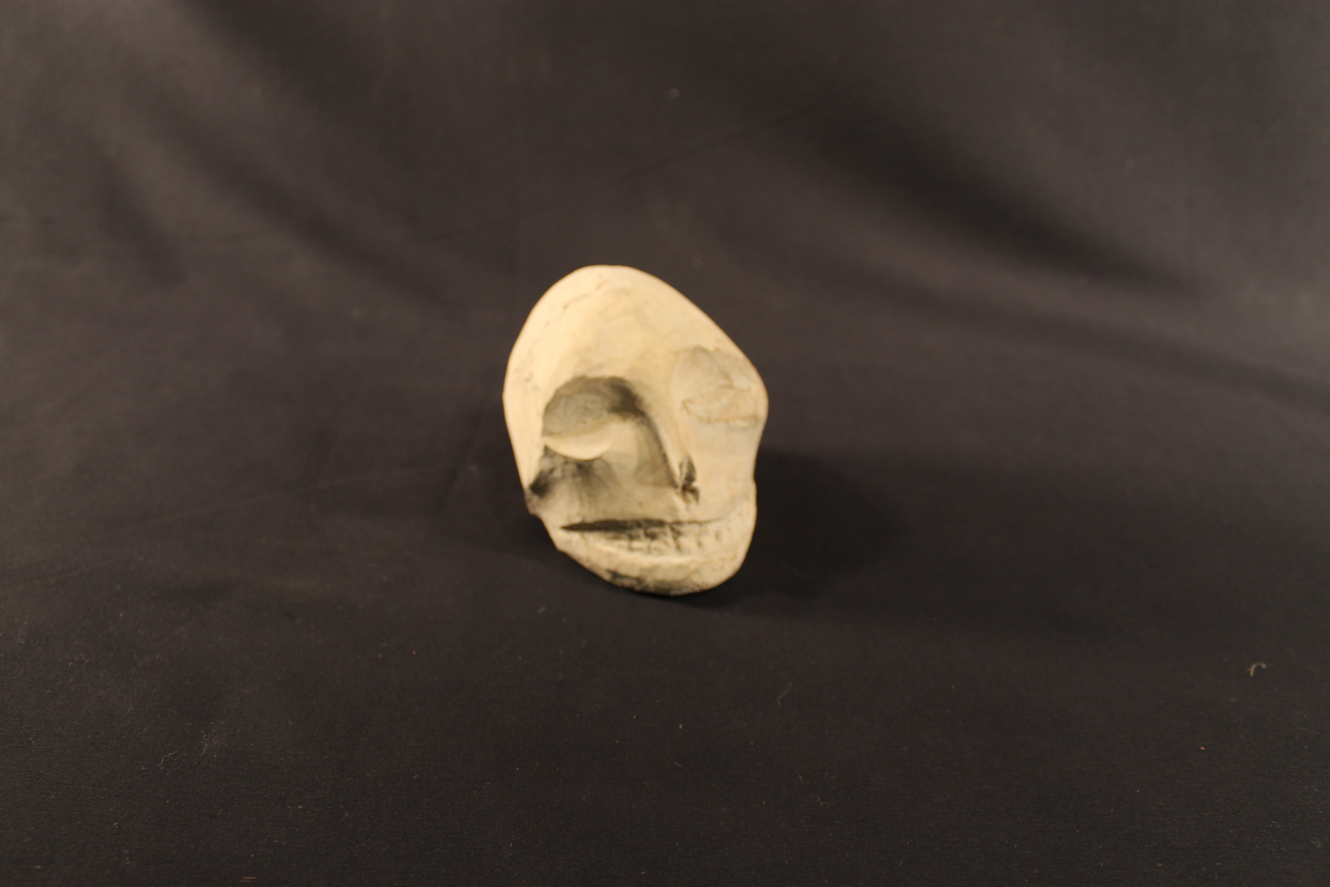 Wooden carving of a human skull
