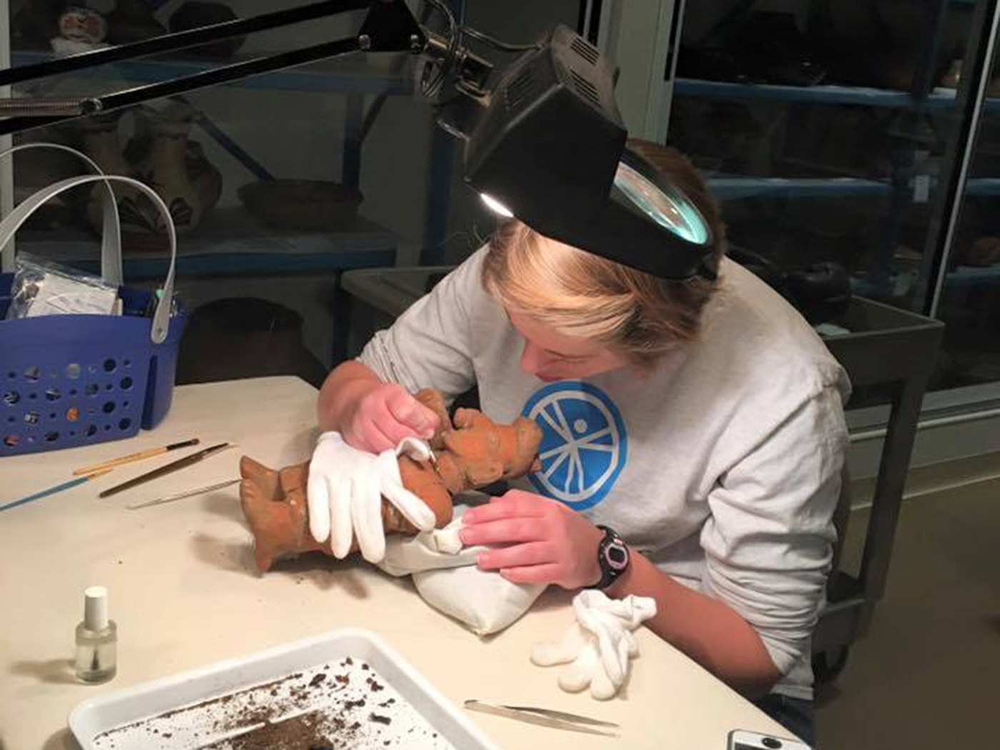 A student prepares an artifact for conservation