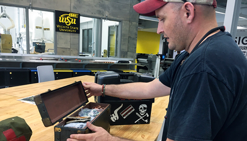 male looking at contents inside a box Male looking at contents inside a box