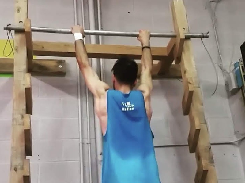 Max Atefi hanging on to high metal bar Max Atefi hanging on to high metal bar